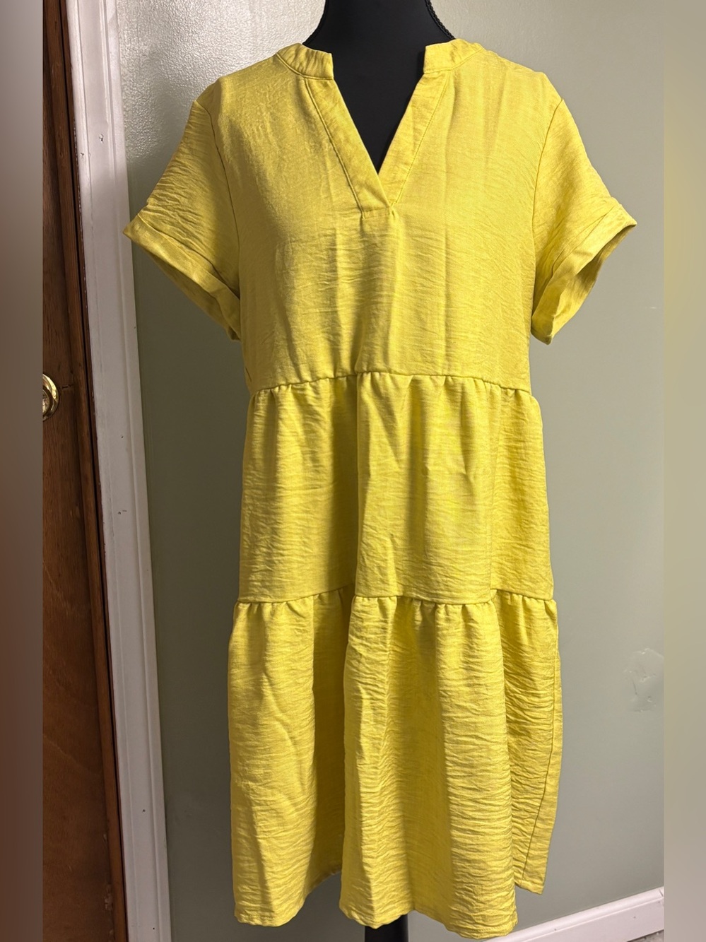 Lightweight tiered shift dress in a bright lime green. Short sleeves V-neck